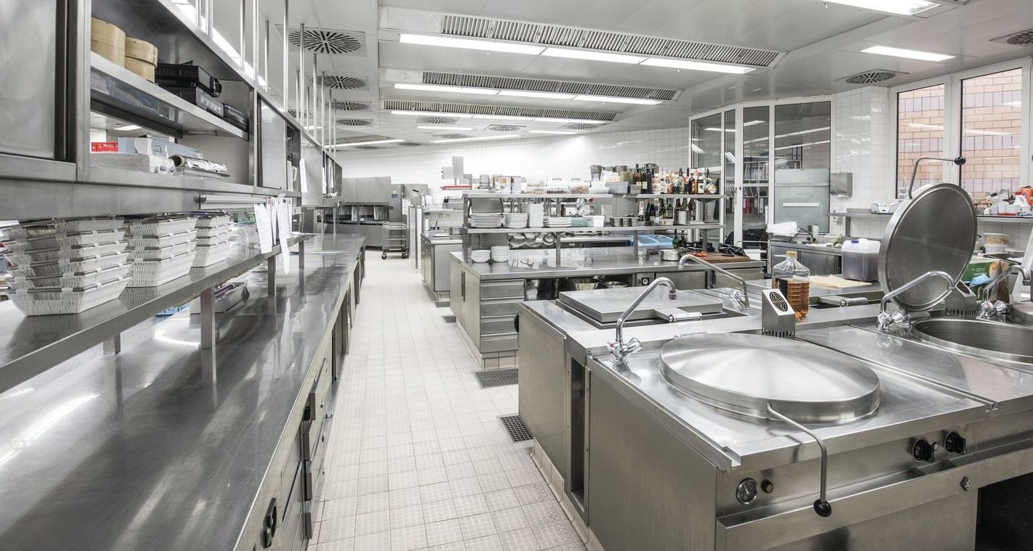 Cleaning of commercial kitchens Full view of clean commercial kitchen