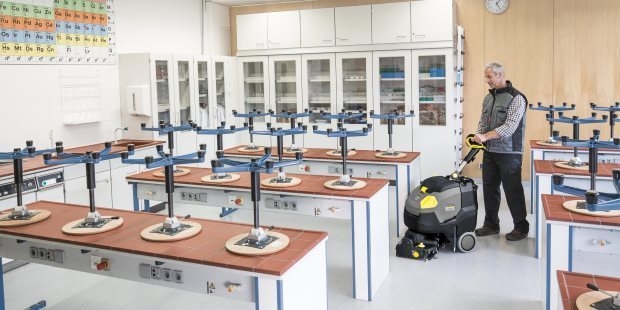 Science Labs & Specialty Rooms A worker cleans floors inside a school science lab.