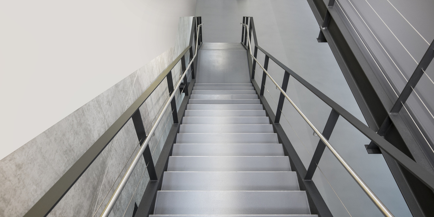 A view of stairs looking from the top down to the bottom.