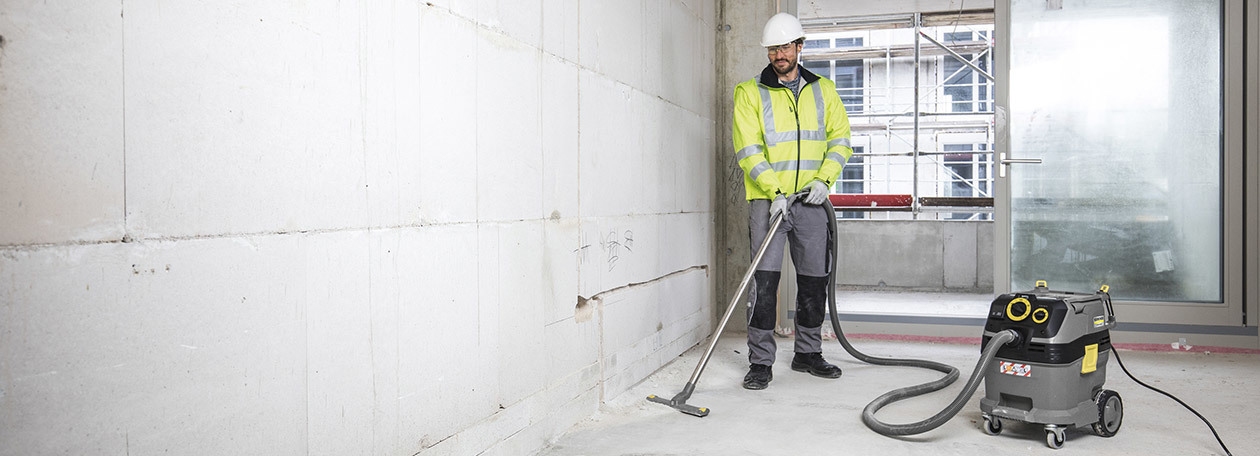 Commercial Wet/Dry Vacuum Rentals A construction worker uses a wet/dry vacuum to clean dust on a job site.