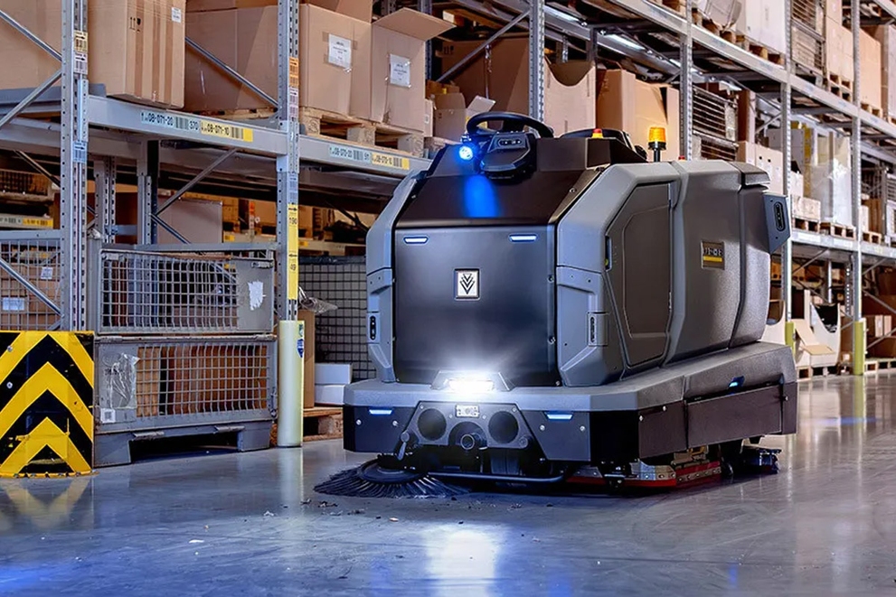 A KIRA B 200 cleans a warehouse floor on its own.