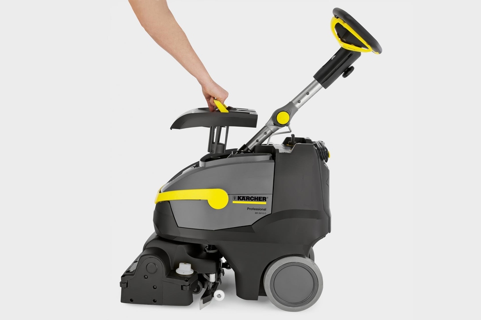 Color-Coded Touchpoints A worker uses the yellow touchpoint on top of a floor scrubber