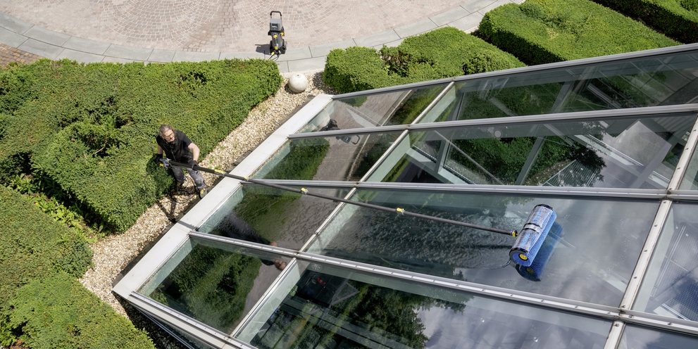A person cleaning the glass facade
