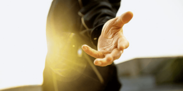 A hand is extended to the viewer
