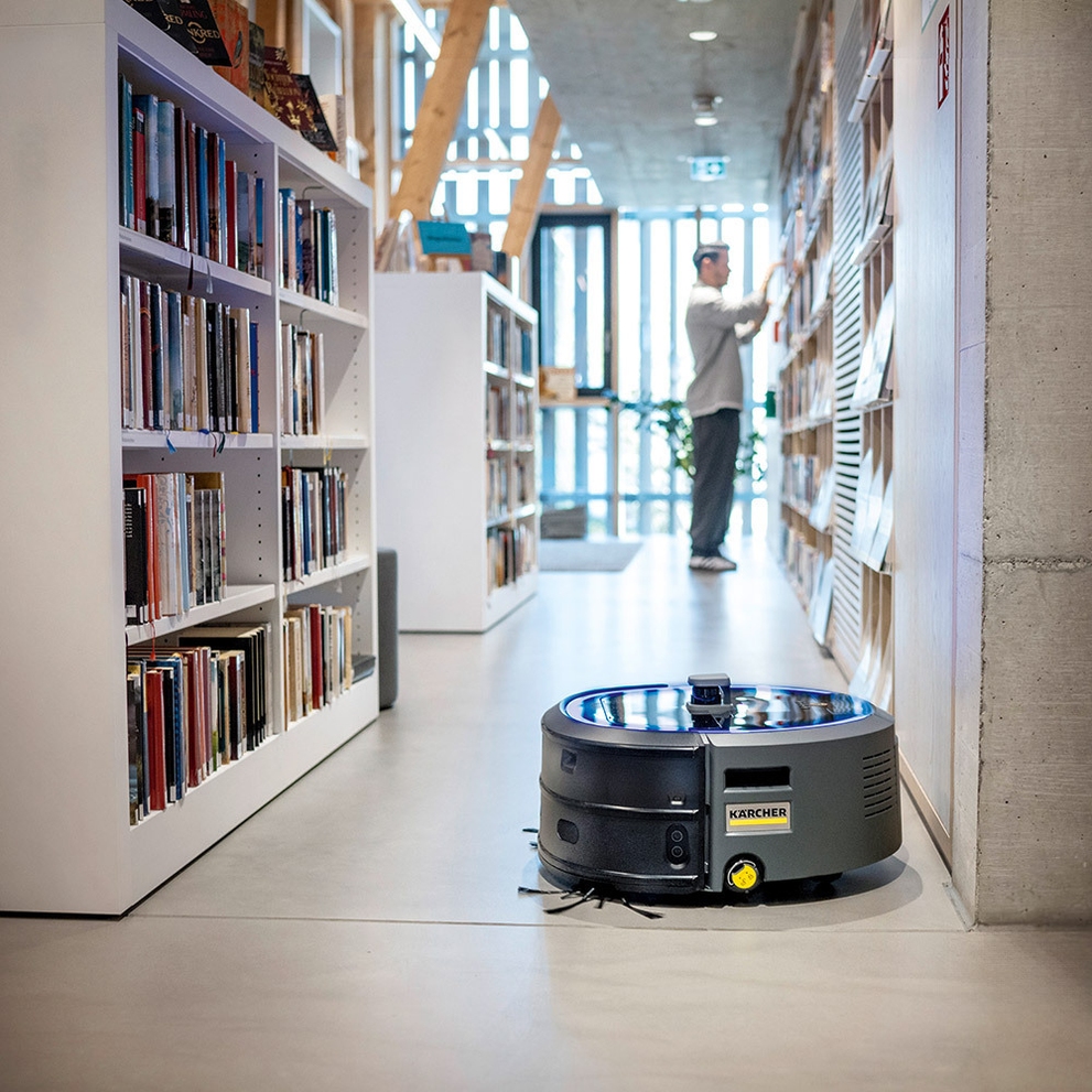 A KIRA CV 50 Robotic Vacuum cleans in a library.