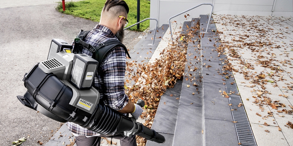 A person is operating a Kärcher leaf blower