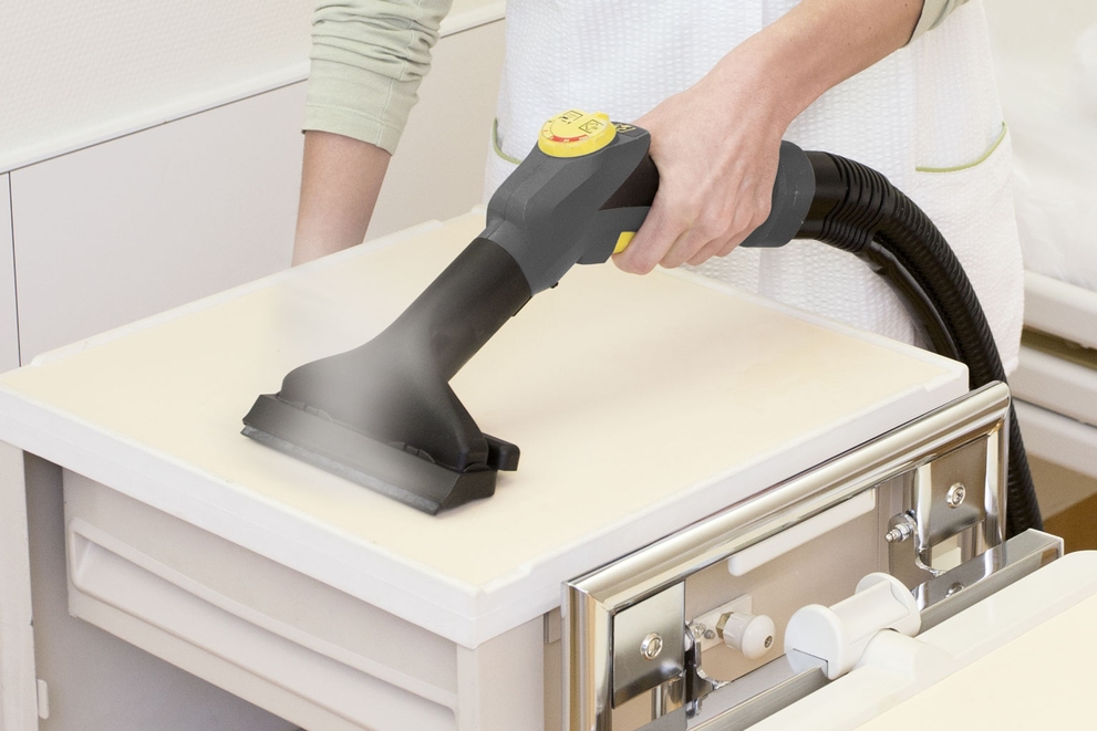 Manual Nozzle with Squeegee Cleaning hospital end tables with a Kärcher steam cleaner with nozzle and squeegee.
