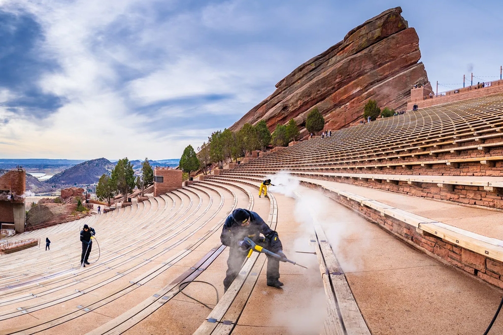 A worker cleans seats at the Red Rock Amphitheatre
