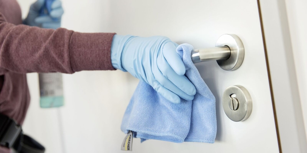 A door handle being cleaned