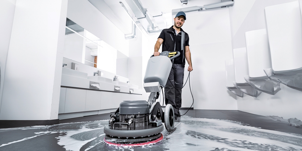 Floor cleaning in the sanitary area with a floor machine.