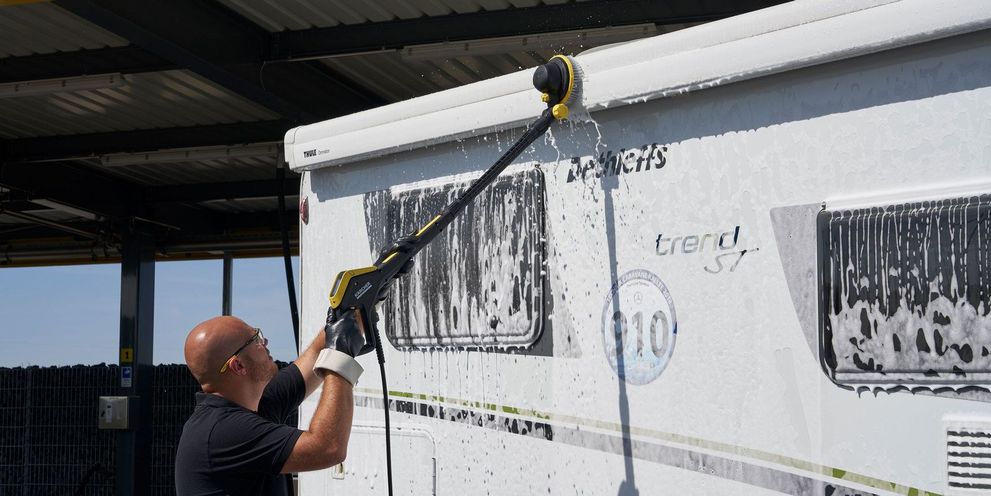 Clean camper with a foaming cleaner Man cleans his caravan with Kärcher Ultra Foam Cleaner
