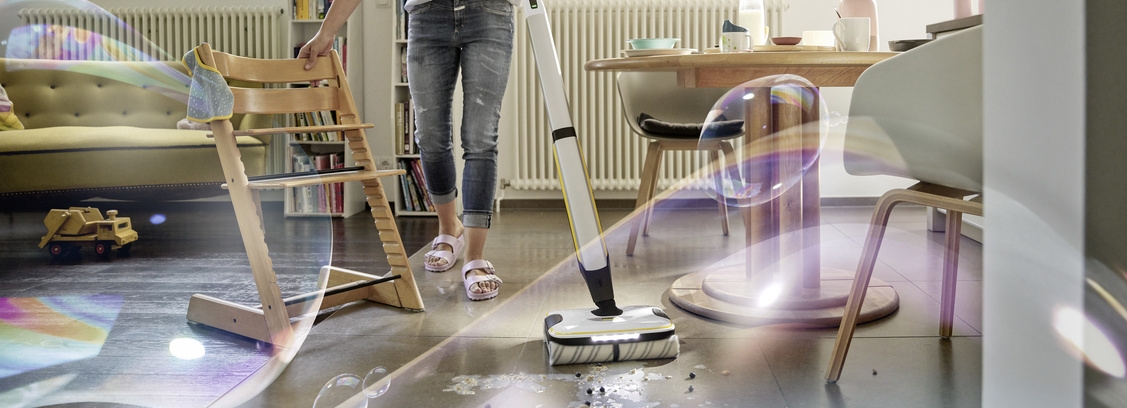 Natural and environmentally friendly floor cleaning A person cleans the floor with a Kärcher product for floor cleaning