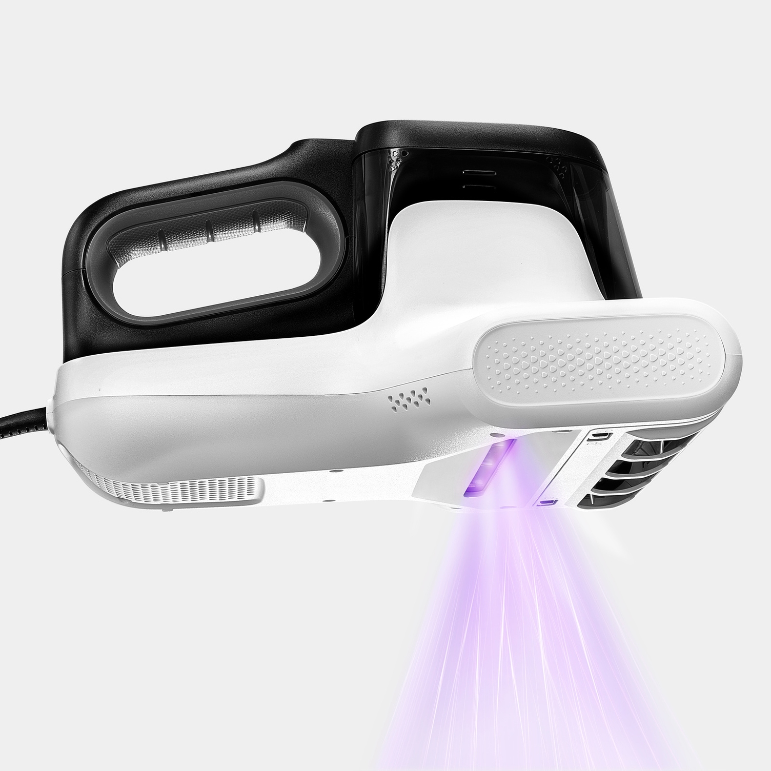 Integrated UV-C light neutralises up to 99.9% of all bacteria and mites The underside of the Kärcher VCH 4 UVClean emitting violet UV-C light onto a textile surface.